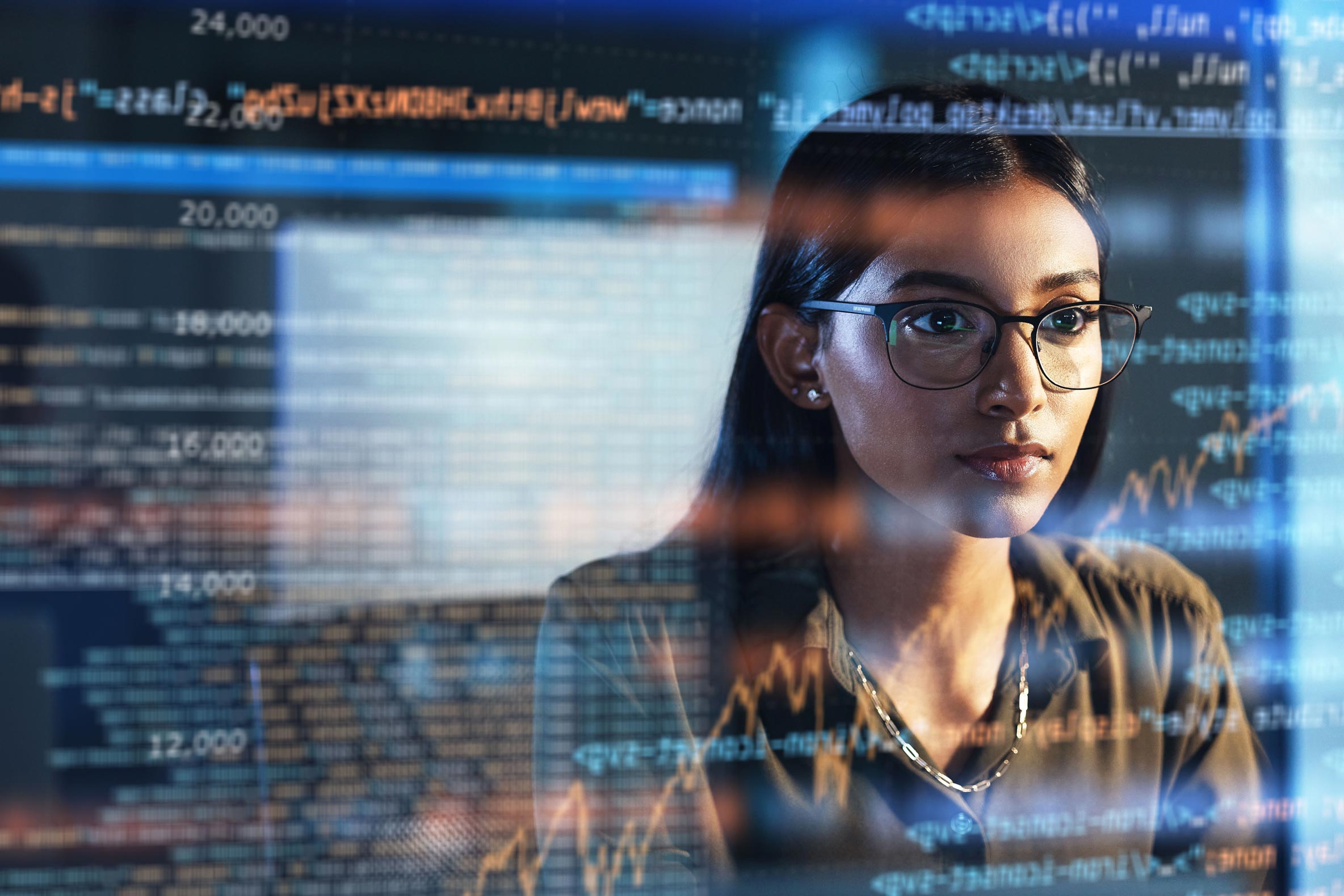 Girl behind a glass screen which displays code